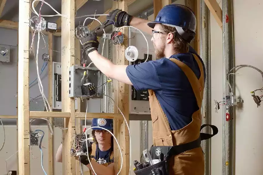 Image of a Certified Electrician wiring a service panel